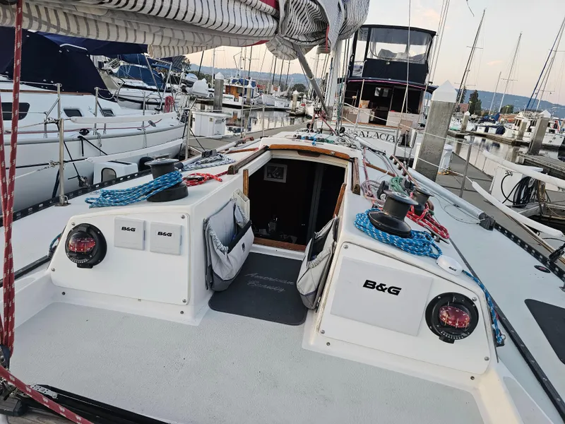 Slide: The Image of 1984 Schock NY 36 sailboat deck with ropes and winches in a marina. - 8