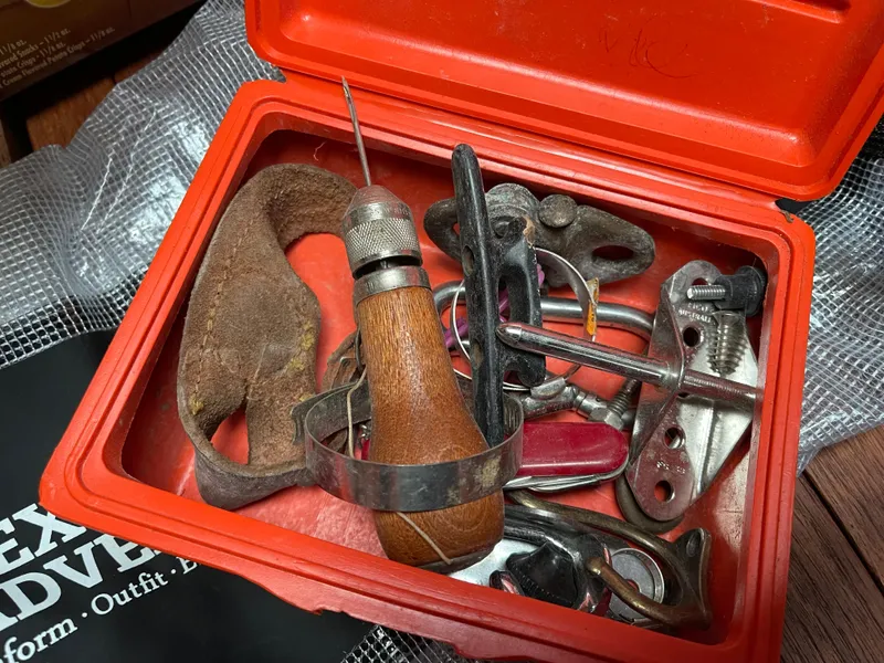 Slide: The Image of Red box containing assorted vintage sailing tools and hardware, related to a 1980 Hinterhoeller Niagra. - 19