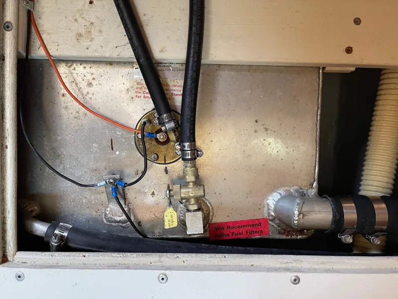 Slide: The Image of 1980 Hinterhoeller Niagra boat engine compartment with fuel lines and fittings. - 23