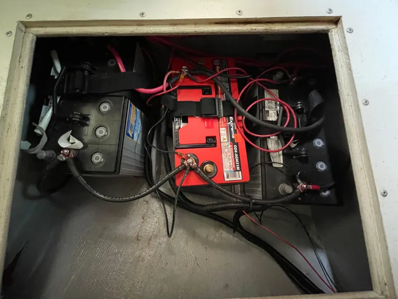 Slide: The Image of 1980 Hinterhoeller Niagra boat battery compartment with wiring and connections. - 24