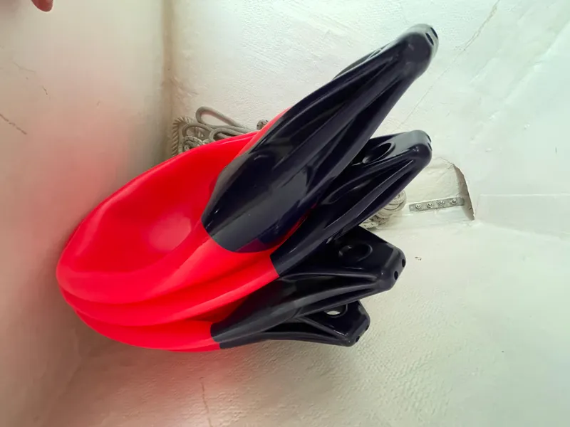 Slide: The Image of Red and black paddles stacked in a corner of a 1980 Hinterhoeller Niagra boat. - 28