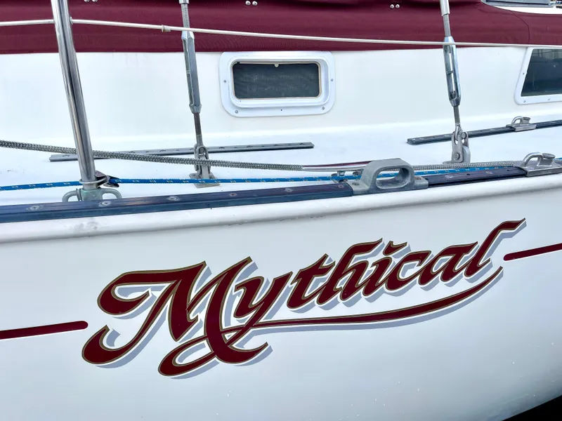 Slide: The Image of 1980 Hinterhoeller Niagra sailboat named "Mythical" with red and white detailing. - 31