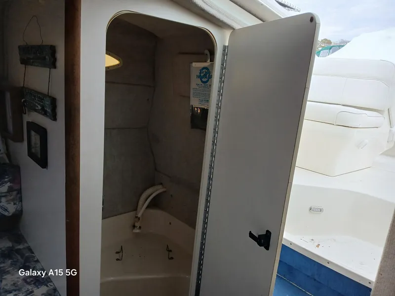 Slide: The Image of Interior view of 1997 Sea Ray 240 Sundancer boat with open cabin door. - 32