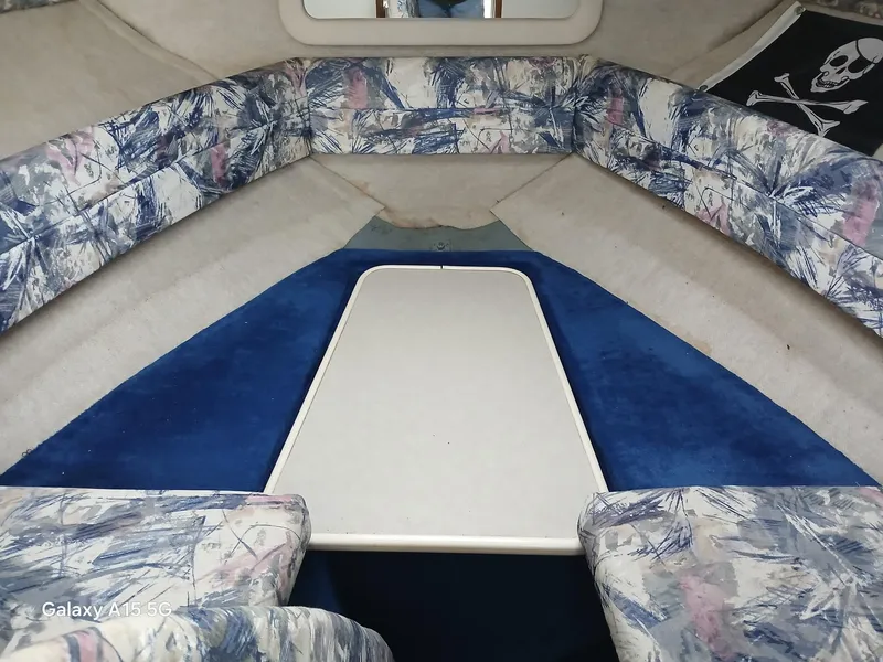Slide: The Image of Interior of 1997 Sea Ray 240 Sundancer boat with floral upholstery and blue carpet. - 23