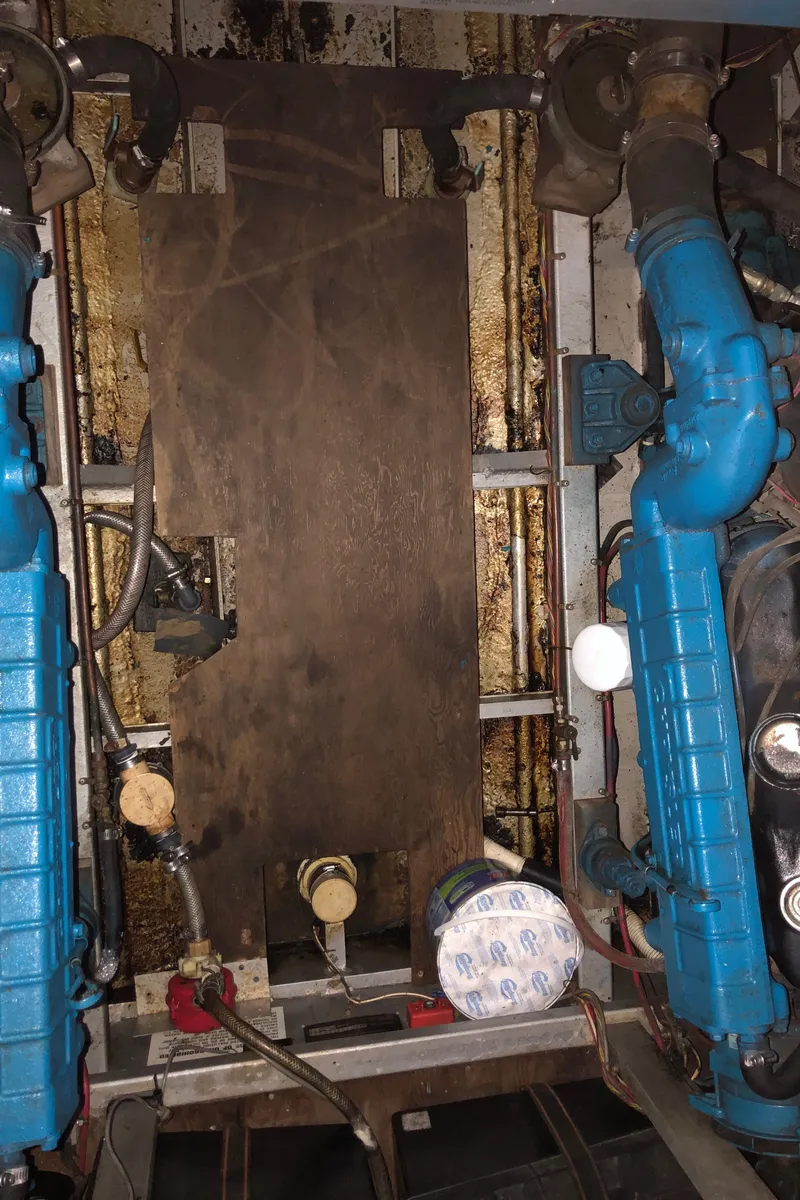 Slide: The Image of Engine room of 1985 Marinette 32 Sedan Flybridge with visible blue machinery components. - 10