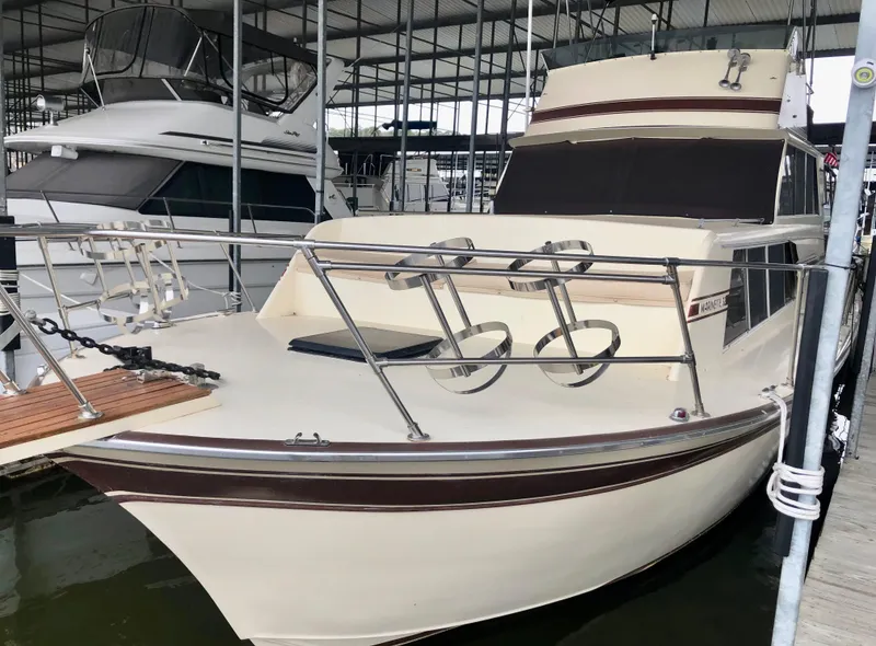 Slide: The Image of 1985 Marinette 32 Sedan Flybridge docked in a marina, showcasing its classic design. - 11