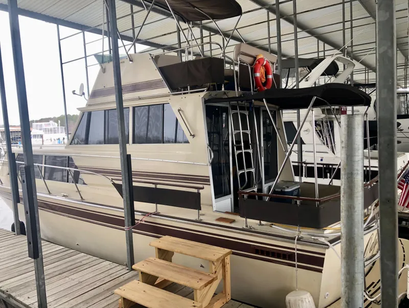 Slide: The Image of 1985 Marinette 32 Sedan Flybridge docked under covered marina. - 12