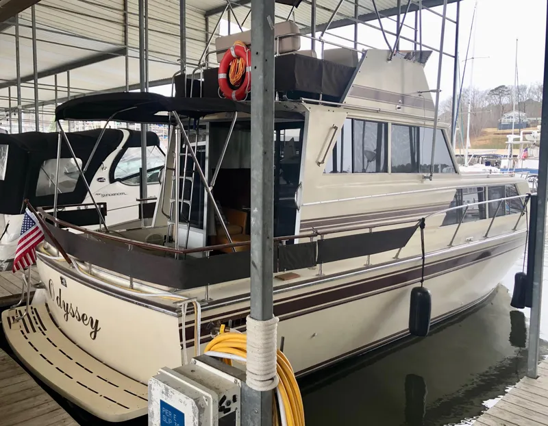 Slide: The Image of 1985 Marinette 32 Sedan Flybridge docked in a marina, featuring classic design and flybridge. - 13