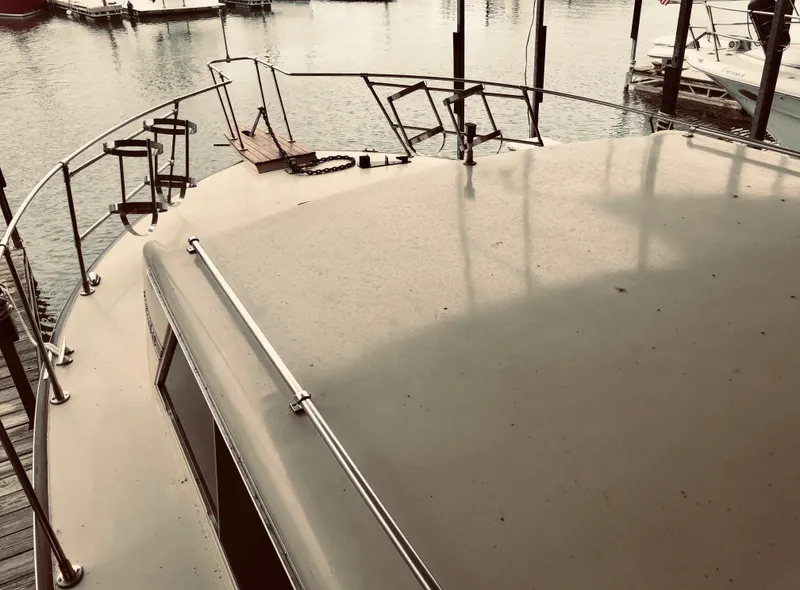 Slide: The Image of 1985 Marinette 32 Sedan Flybridge boat docked at marina, top view. - 15