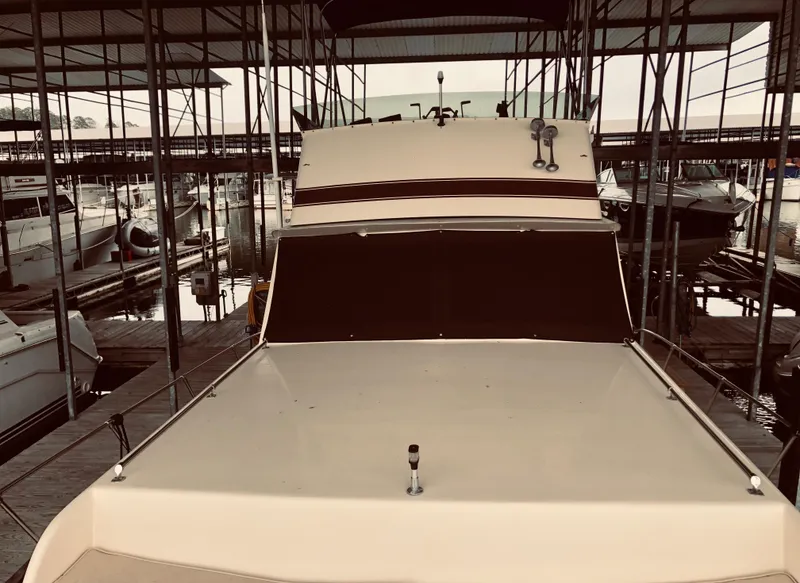 Slide: The Image of 1985 Marinette 32 Sedan Flybridge docked in a marina. - 16