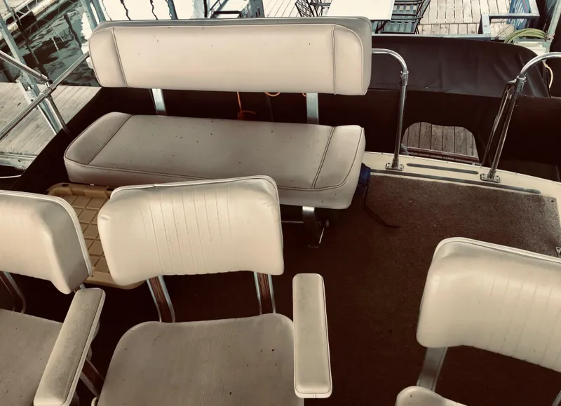 Slide: The Image of 1985 Marinette 32 Sedan Flybridge interior with white seating and carpeted floor. - 20