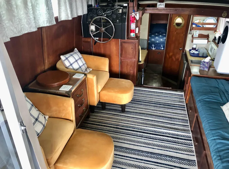 Slide: The Image of Interior of 1985 Marinette 32 Sedan Flybridge with cozy seating and nautical decor. - 22
