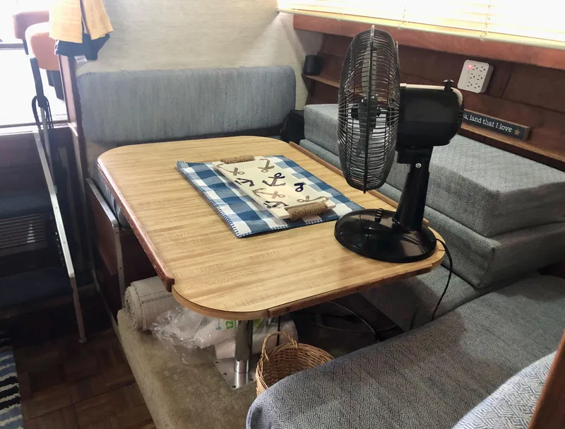 Slide: The Image of Interior of 1985 Marinette 32 Sedan Flybridge with table, fan, and seating. - 29