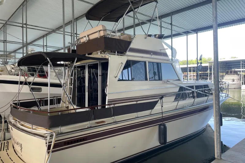 Slide: The Image of 1985 Marinette 32 Sedan Flybridge docked in a covered marina. - 4