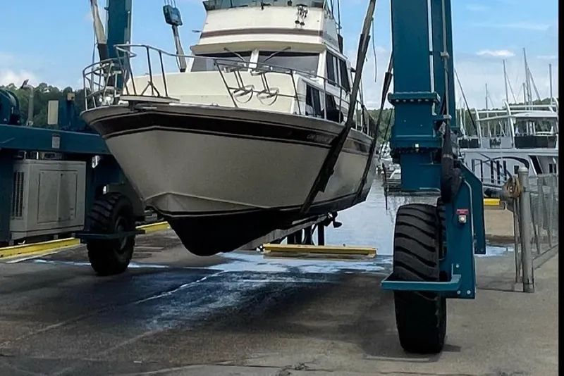Slide: The Image of 1985 Marinette 32 Sedan Flybridge being lifted at a marina. - 5