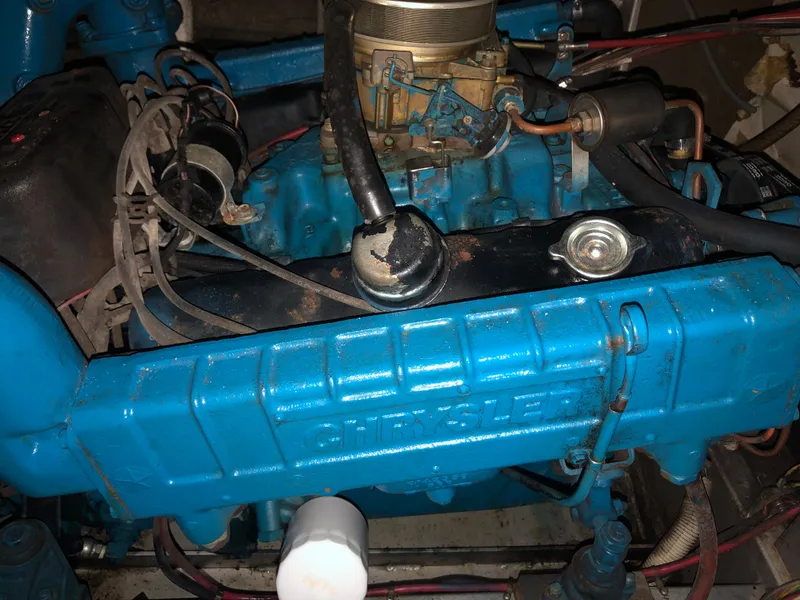 Slide: The Image of 1985 Marinette 32 Sedan Flybridge engine, featuring a blue Chrysler motor. - 9
