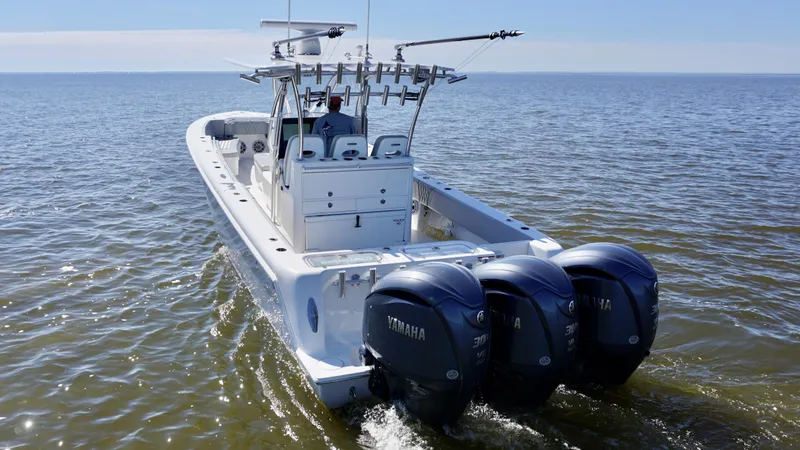 Slide: The Image of 2023 Contender 35 ST boat with triple Yamaha engines on open water. - 11