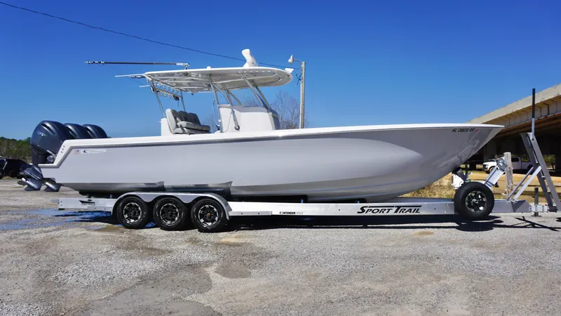 Slide: The Image of 2023 Contender 35 ST boat on trailer, featuring triple engines and sleek design. - 13