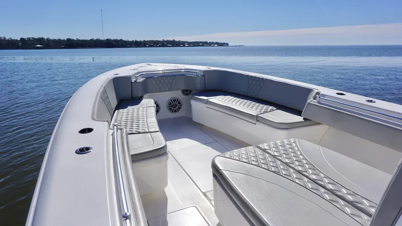 Slide: The Image of 2023 Contender 35 ST boat interior with cushioned seating on calm water. - 15