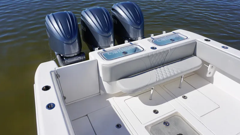 Slide: The Image of 2023 Contender 35 ST boat with triple outboard engines and spacious seating area. - 16