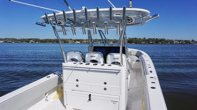 Slide: The Image of 2023 Contender 35 ST boat on calm water, featuring a spacious deck and rod holders. - 18