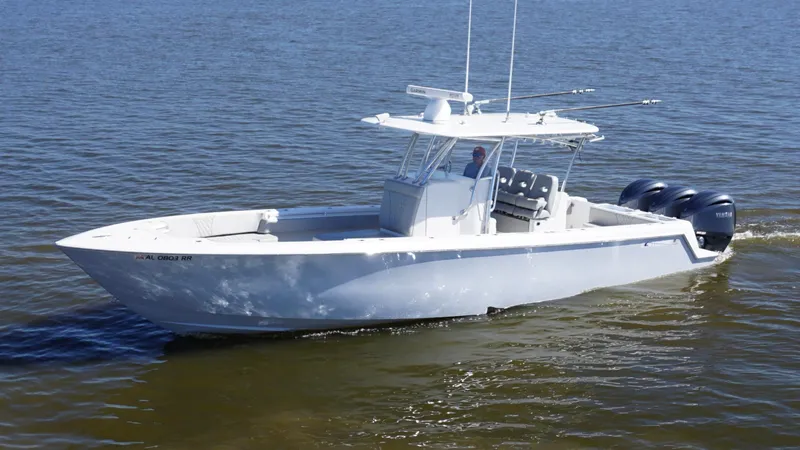 Slide: The Image of 2023 Contender 35 ST boat cruising on open water with triple outboard engines. - 2