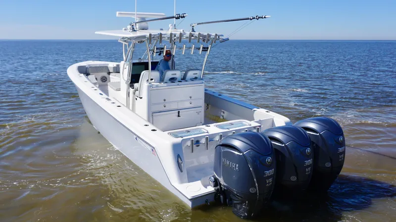 Slide: The Image of 2023 Contender 35 ST boat with triple Yamaha engines on open water. - 3