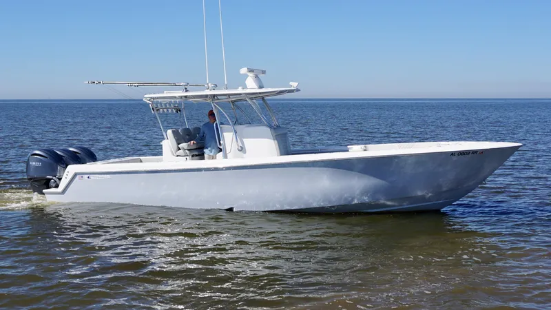 Slide: The Image of 2023 Contender 35 ST boat on calm water, featuring a spacious deck and rod holders. - 4