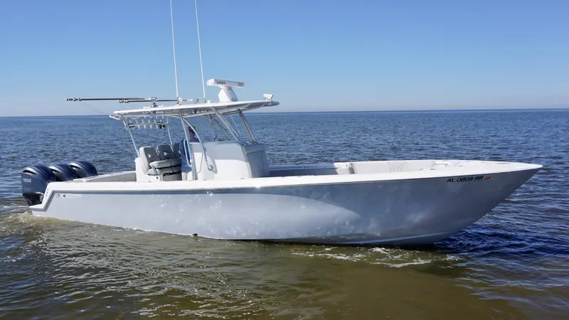 Slide: The Image of 2023 Contender 35 ST boat on calm water, featuring triple outboard engines. - 6