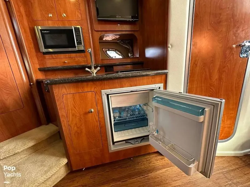 Slide: The Image of Interior of 2013 Rinker 310 Express Cruiser with kitchenette. - 11