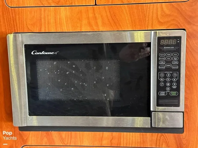 Slide: The Image of Microwave in a 2013 Rinker 310 Express Cruiser kitchen. - 12
