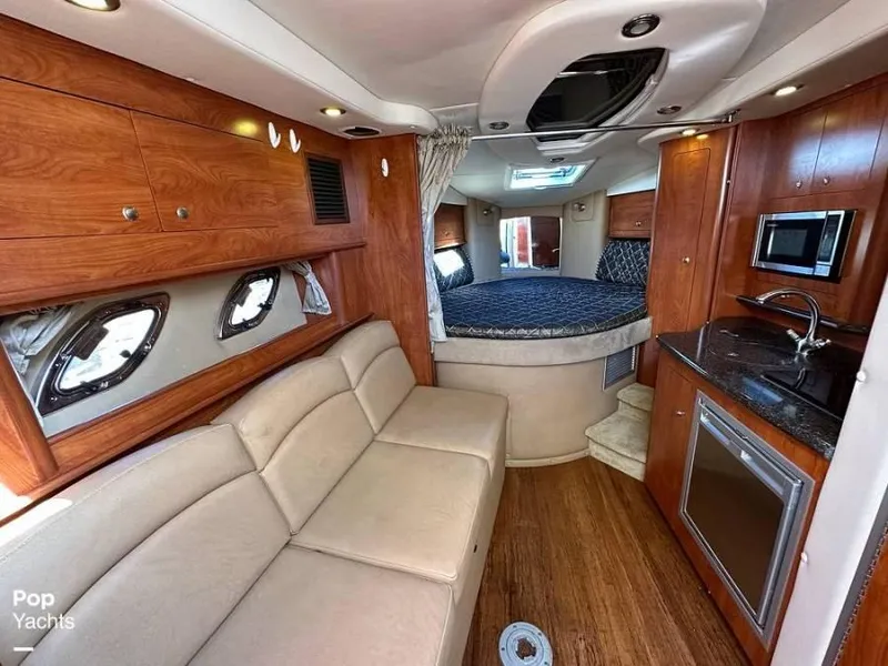 Slide: The Image of Interior of 2013 Rinker 310 Express Cruiser with sofa and kitchenette. - 14