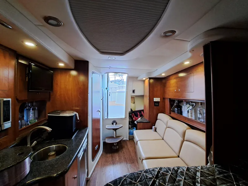 Slide: The Image of Interior of 2013 Rinker 310 Express Cruiser with modern amenities. - 16