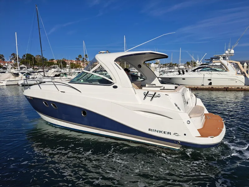 Slide: The Image of 2013 Rinker 310 Express Cruiser in harbor, sunny day. - 2