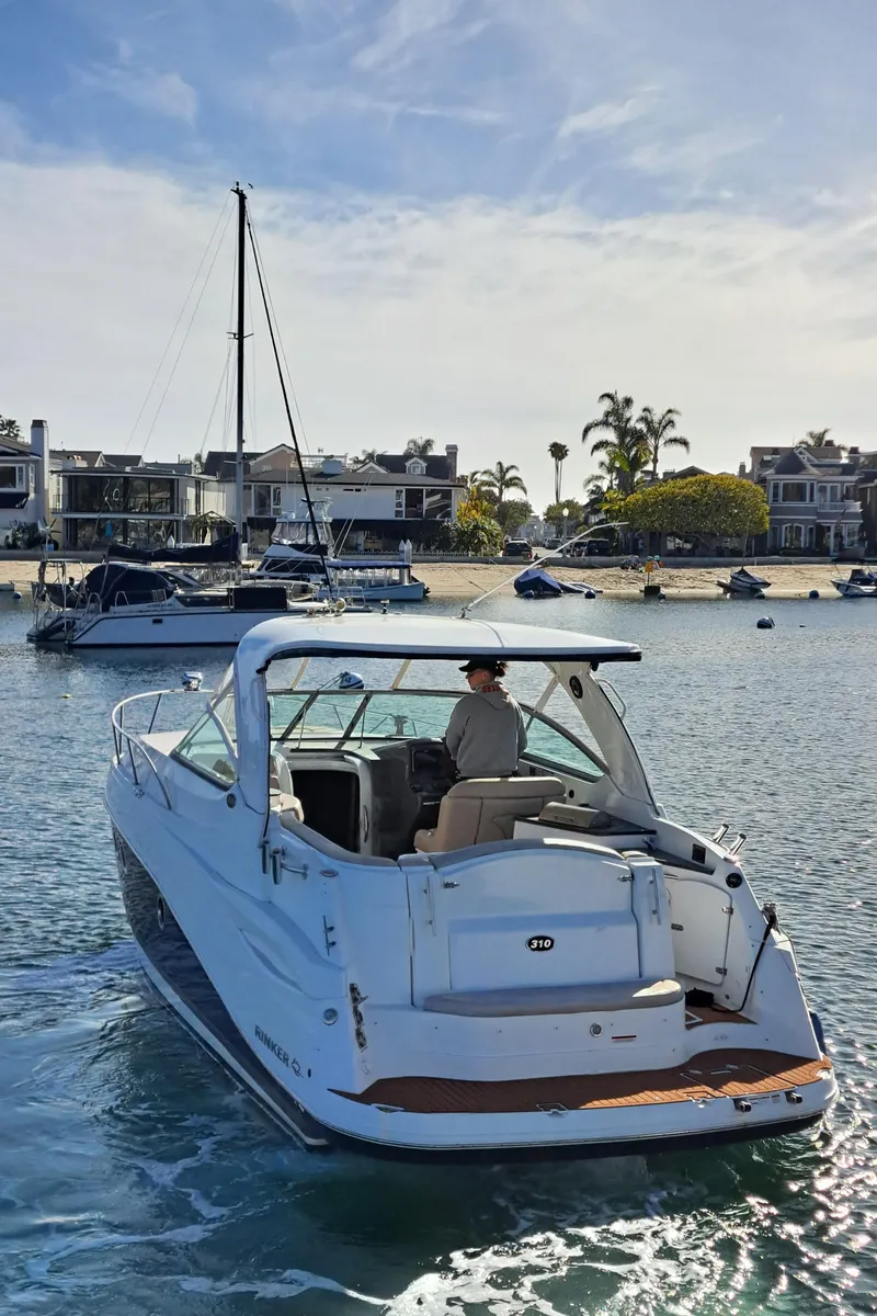Slide: The Image of 2013 Rinker 310 Express Cruiser on calm waters. - 5