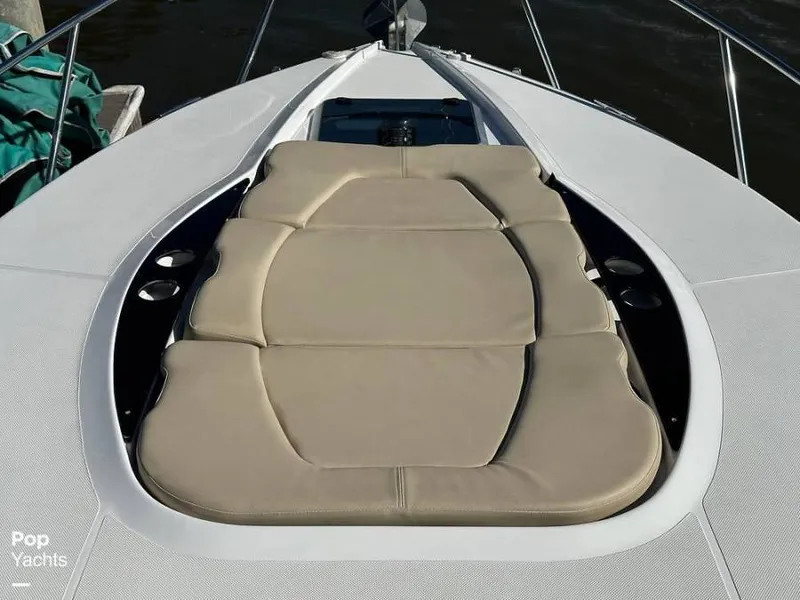 Slide: The Image of 2013 Rinker 310 Express Cruiser with cushioned sun deck. - 8