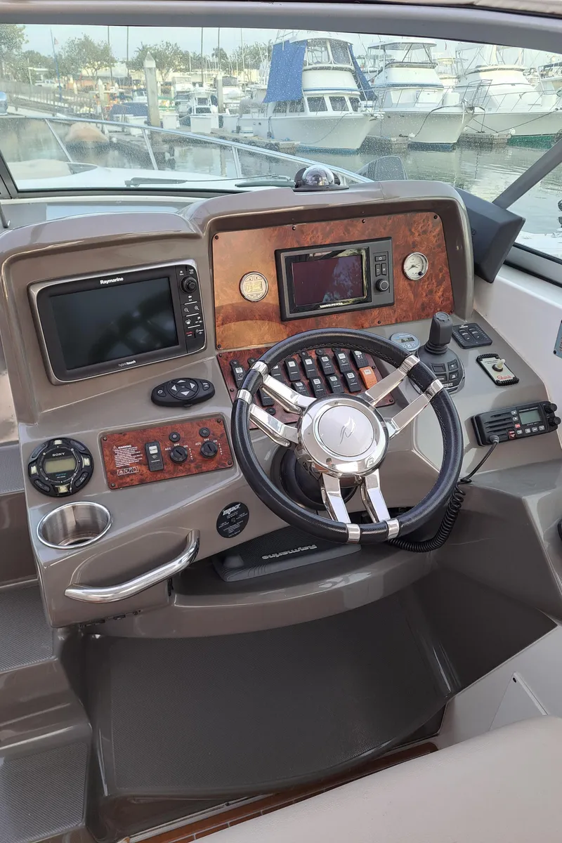 Slide: The Image of Helm of 2013 Rinker 310 Express Cruiser at the marina. - 9