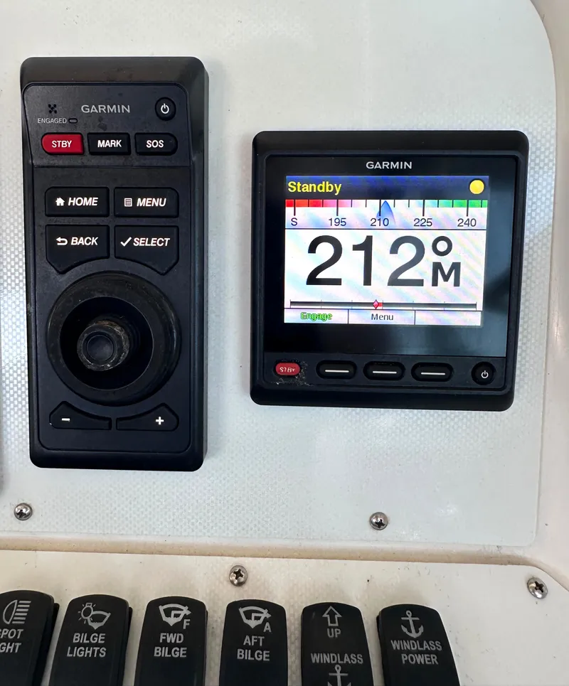 Slide: The Image of Dashboard of a 1997 Sea Ray 370 Express Cruiser with multiple gauges. - 12