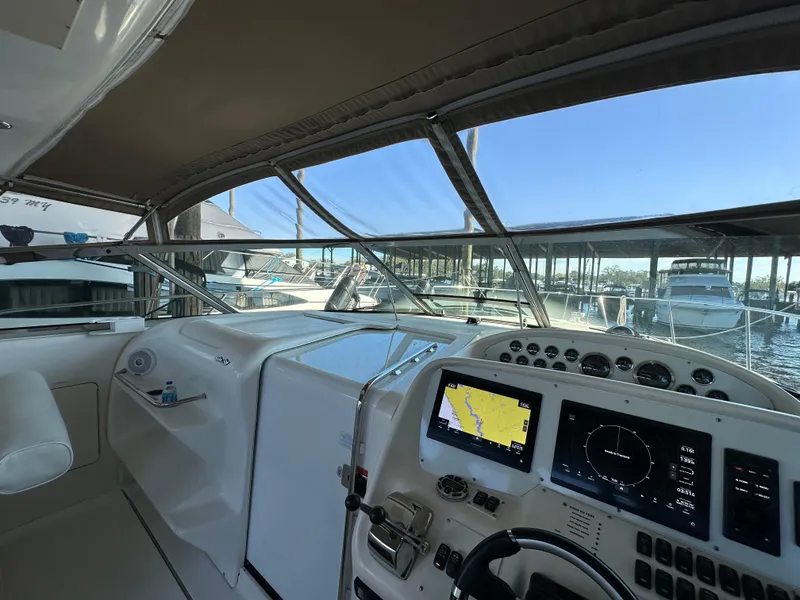 Slide: The Image of Cockpit of 1997 Sea Ray 370 Express Cruiser with navigation screens and controls. - 16