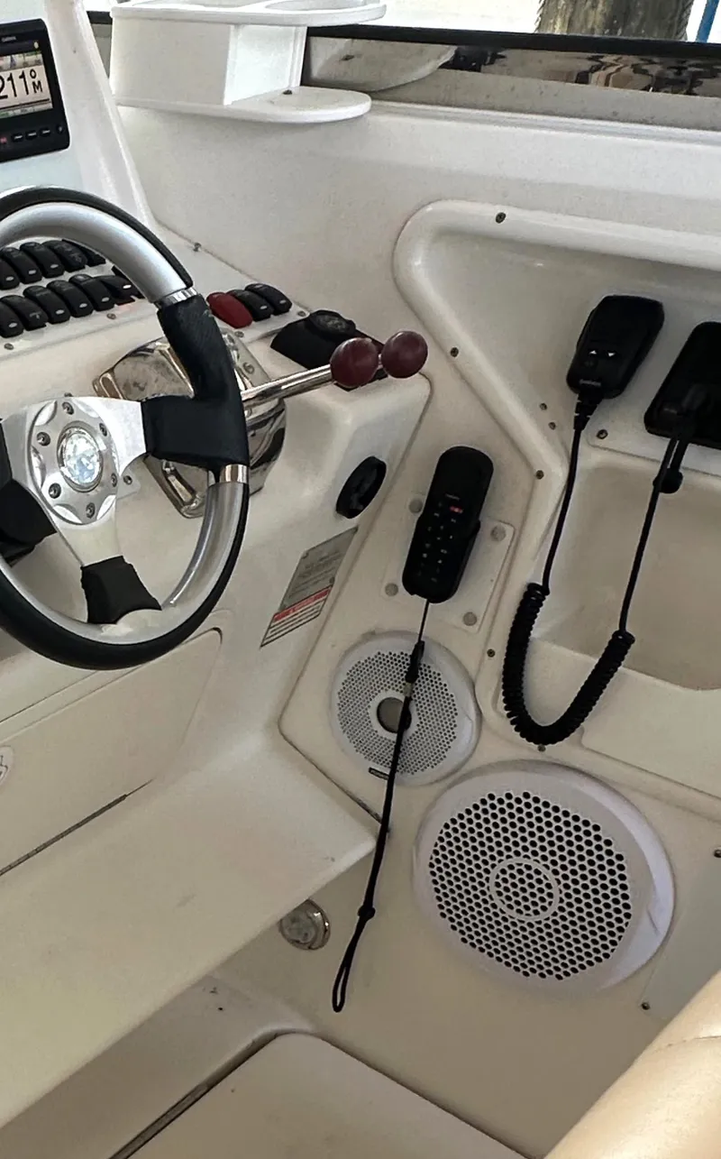 Slide: The Image of 1997 Sea Ray 370 Express Cruiser cockpit with navigation system and marina view. - 17