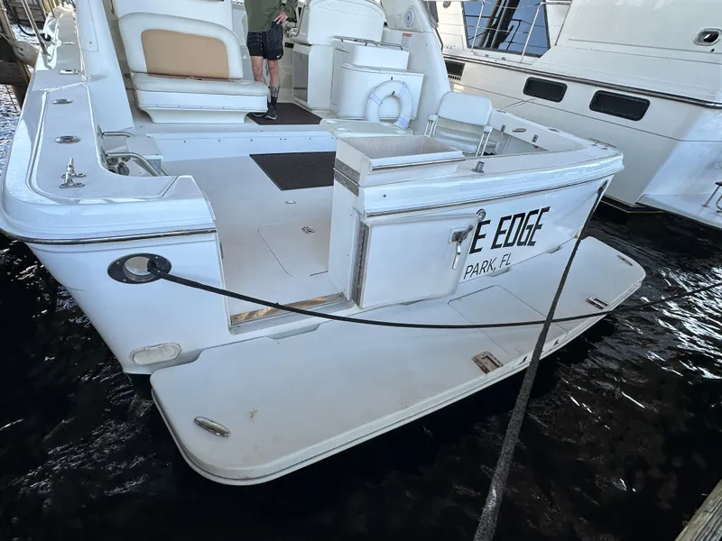 Slide: The Image of 1997 Sea Ray 370 Express Cruiser deck with seating, table, and ocean view. - 19