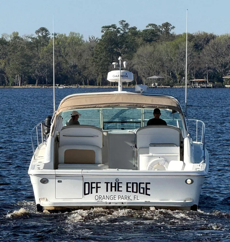Slide: The Image of 1997 Sea Ray 370 Express Cruiser interior with kitchen, seating, and sleeping area. - 2