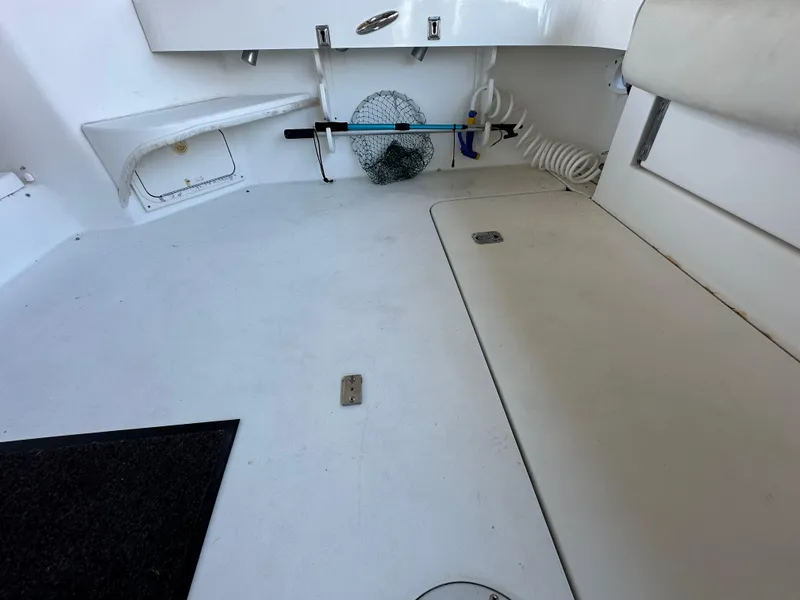 Slide: The Image of 1997 Sea Ray 370 Express Cruiser interior with coiled hose and porthole view. - 25