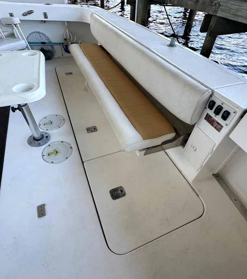 Slide: The Image of 1997 Sea Ray 370 Express Cruiser interior with white seating and storage compartments. - 26