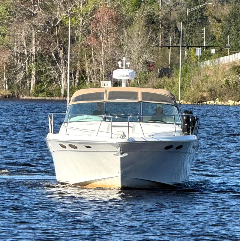Slide: The Image of 1997 Sea Ray 370 Express Cruiser, spacious deck, cruising on open water. - 3
