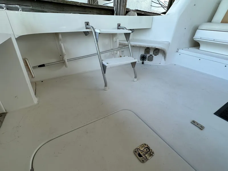 Slide: The Image of 1997 Sea Ray 370 Express Cruiser deck with utility connections and storage area. - 30