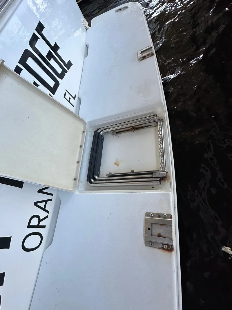 Slide: The Image of 1997 Sea Ray 370 Express Cruiser interior with white deck and foldable ladder. - 31