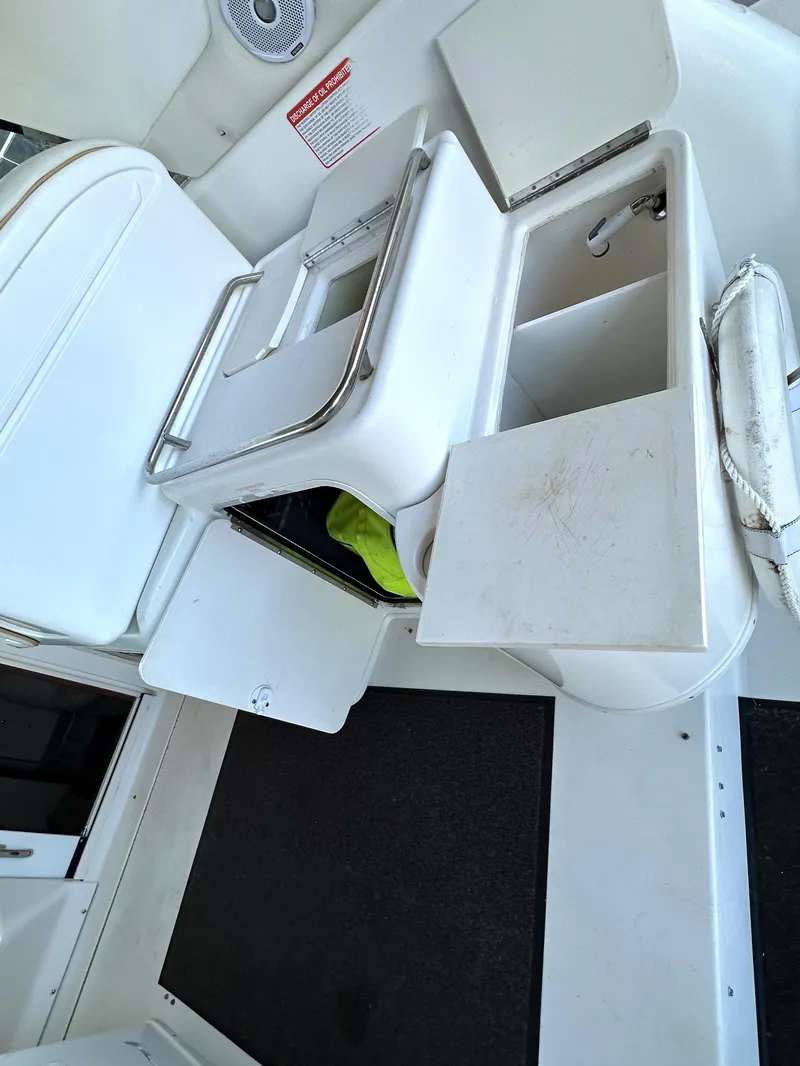 Slide: The Image of 1997 Sea Ray 370 Express Cruiser interior with white seating and helm station. - 33