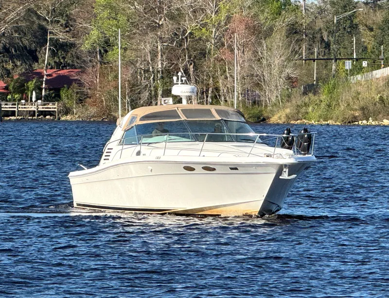 Slide: The Image of 1997 Sea Ray 370 Express Cruiser on water near a bridge. - 4