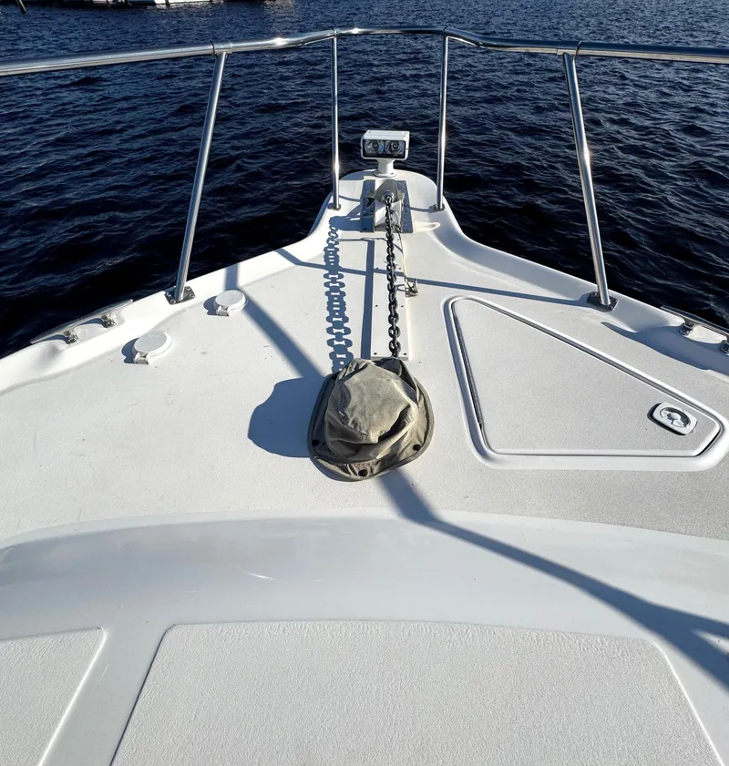 Slide: The Image of Bow of 1997 Sea Ray 370 Express Cruiser with anchor chain, on calm water. - 44